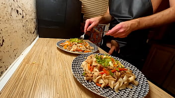 Super-sexy cooking. Naked fag chef is cooking rice noodle with chicken and vegetables