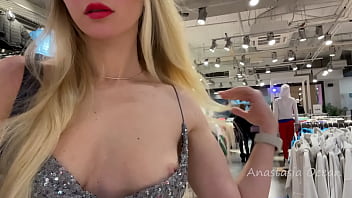 Uber-cute damsel in a beautiful dress flashes orbs in a public store.