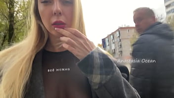 A gal shows her baps while walking in public in the city